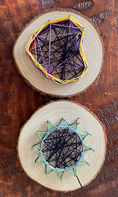 String Art project - hearts and star on a cross section of wood